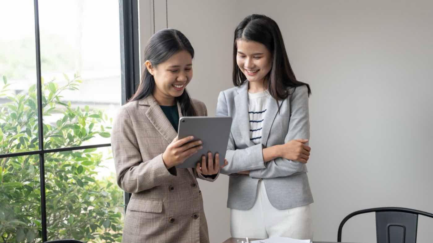 Cashflow smoothing: a small business owner planning month-to-month spend on a tablet